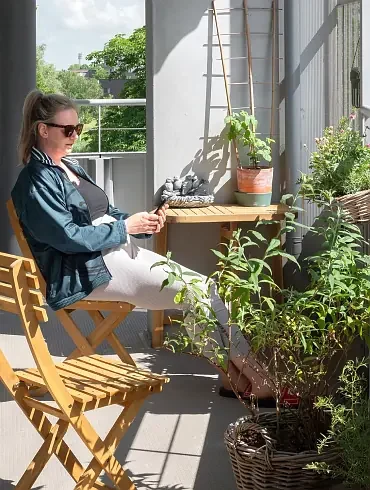 Woman on a shared terrace at her apartment